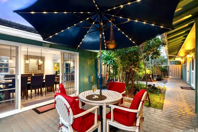 a view of backyard with swimming pool and outdoor seating
