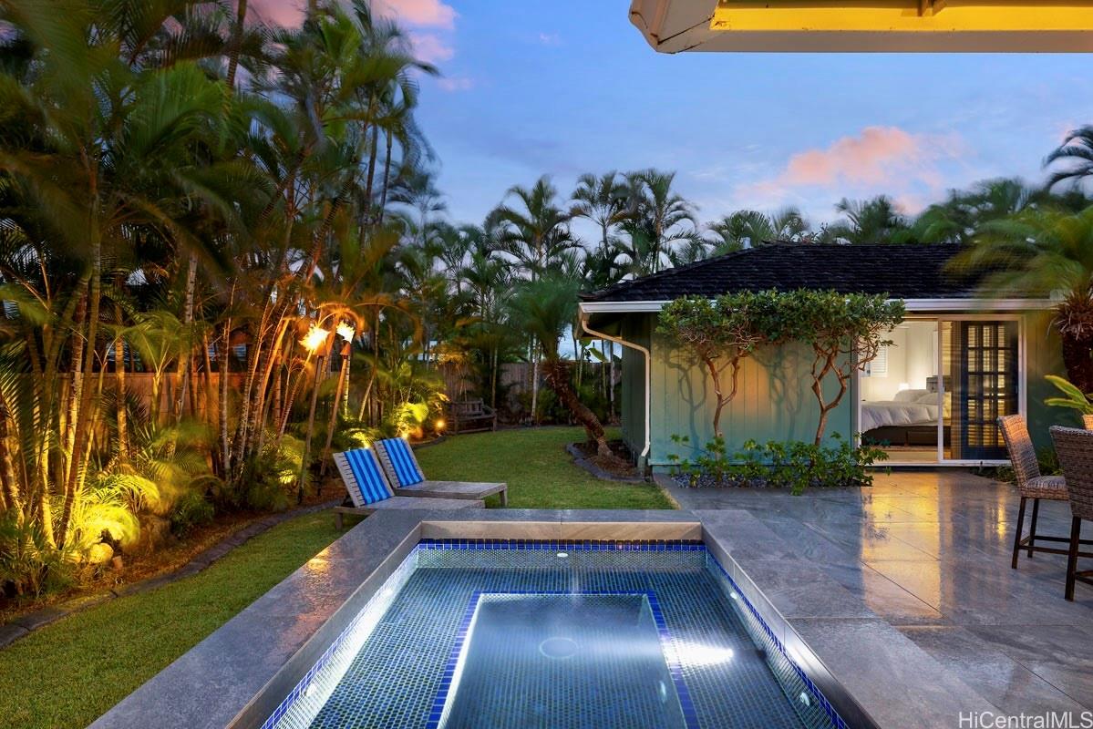 49 Pilipu Place Kailua, HI 96734 - Photo 21 of 25 Tiki Torches w/ Hot Tub and Yard at Dusk
