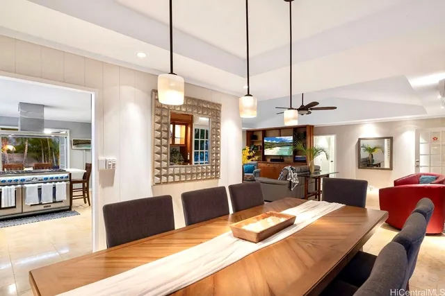 a view of a dining room and livingroom furniture wooden floor a chandelier