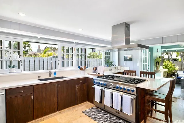 a kitchen with stainless steel appliances granite countertop a sink and wooden cabinets