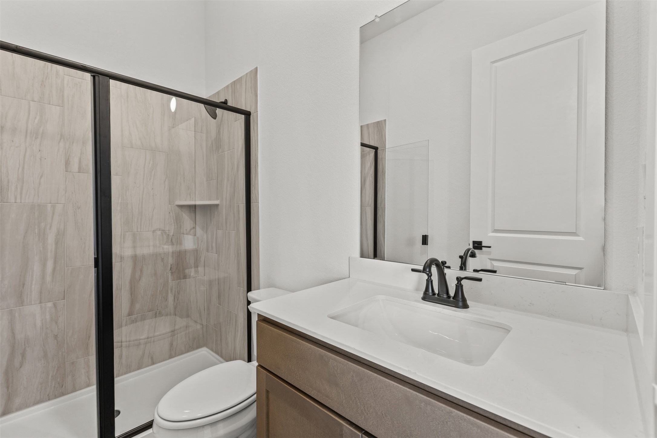 1420 Barth Road Dale, TX 78616 - Photo 25 of 37 A well-appointed bath features a sleek vanity, modern fixtures, and a glass-enclosed shower.