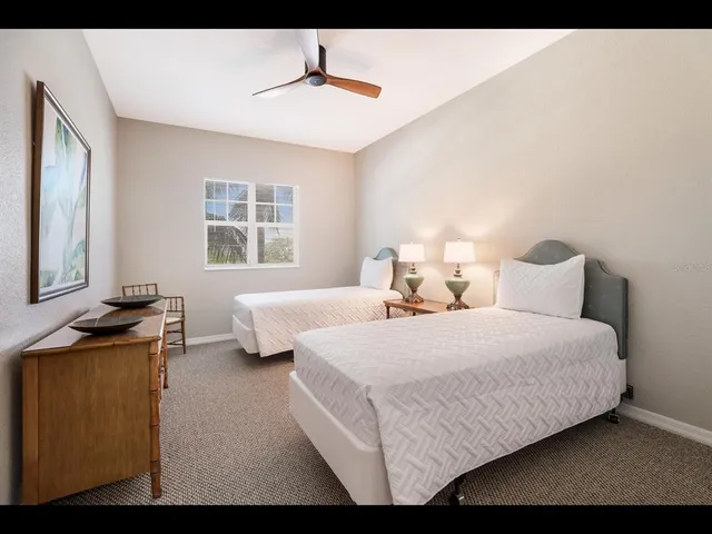 a bedroom with a bed and painting on the wall