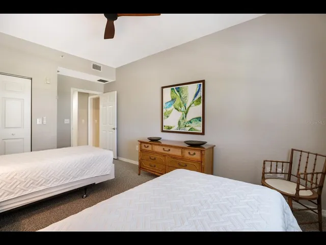 a bathroom with a sink a toilet and a large mirror