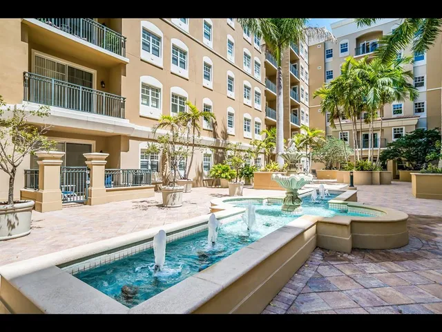 a view of a white building with a swimming pool