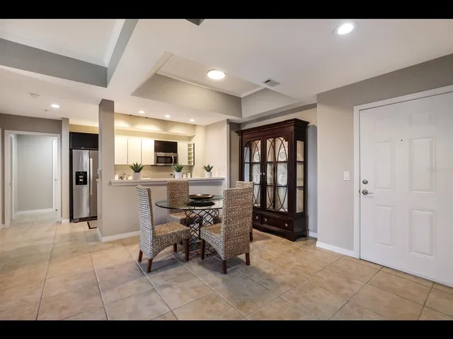 a kitchen with stainless steel appliances kitchen island granite countertop a stove a refrigerator and a microwave