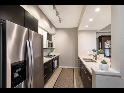 a kitchen with a sink cabinets and microwave
