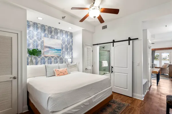 a bedroom with a bed and a chandelier
