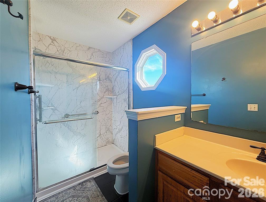 7456 Courtney Pines Road Wilmington, NC 28411 - Photo 11 of 16 a bathroom with a toilet and a shower