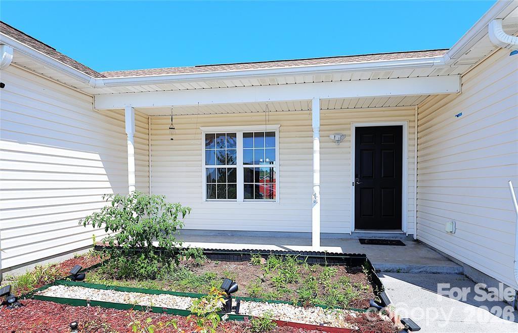 7456 Courtney Pines Road Wilmington, NC 28411 - Photo 3 of 16 a front view of a house with a yard