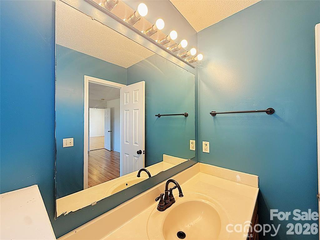 7456 Courtney Pines Road Wilmington, NC 28411 - Photo 9 of 16 a bathroom with a sink and a mirror