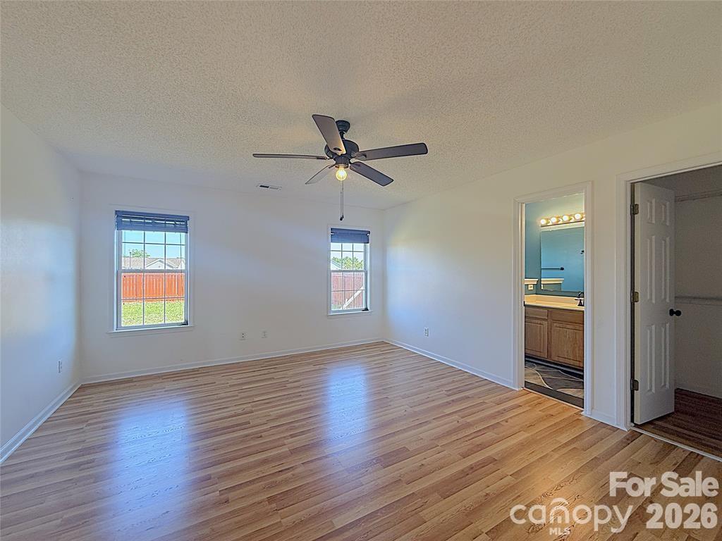 7456 Courtney Pines Road Wilmington, NC 28411 - Photo 10 of 16 a view of empty room with wooden floor and window