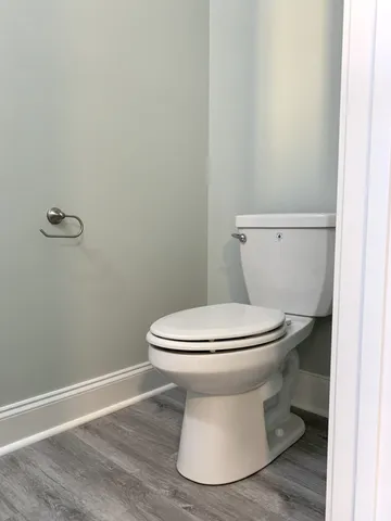 a white toilet sitting next to a white sink
