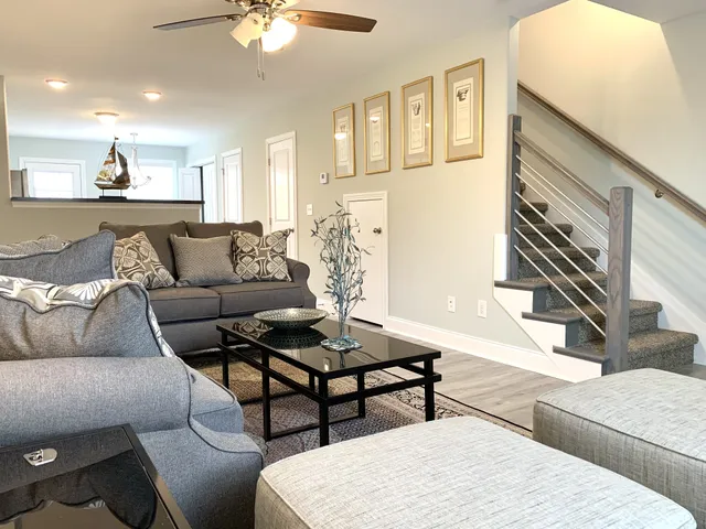 a living room with furniture and a chandelier