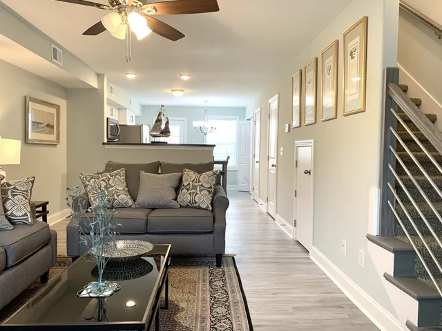 a living room with furniture and a chandelier