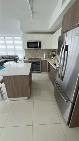 a kitchen with stainless steel appliances granite countertop a sink and a stove