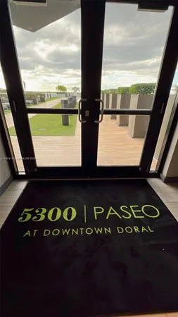 a front view of a building with glass top table and chairs