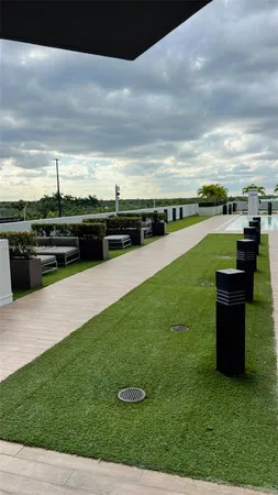 a front view of a building with palm trees