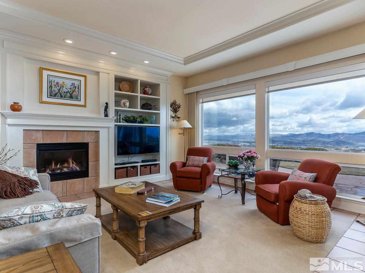 541 Spirit Ridge Court Reno, NV 89511 - Photo 8 of 32 a living room with furniture a flat screen tv and a fireplace