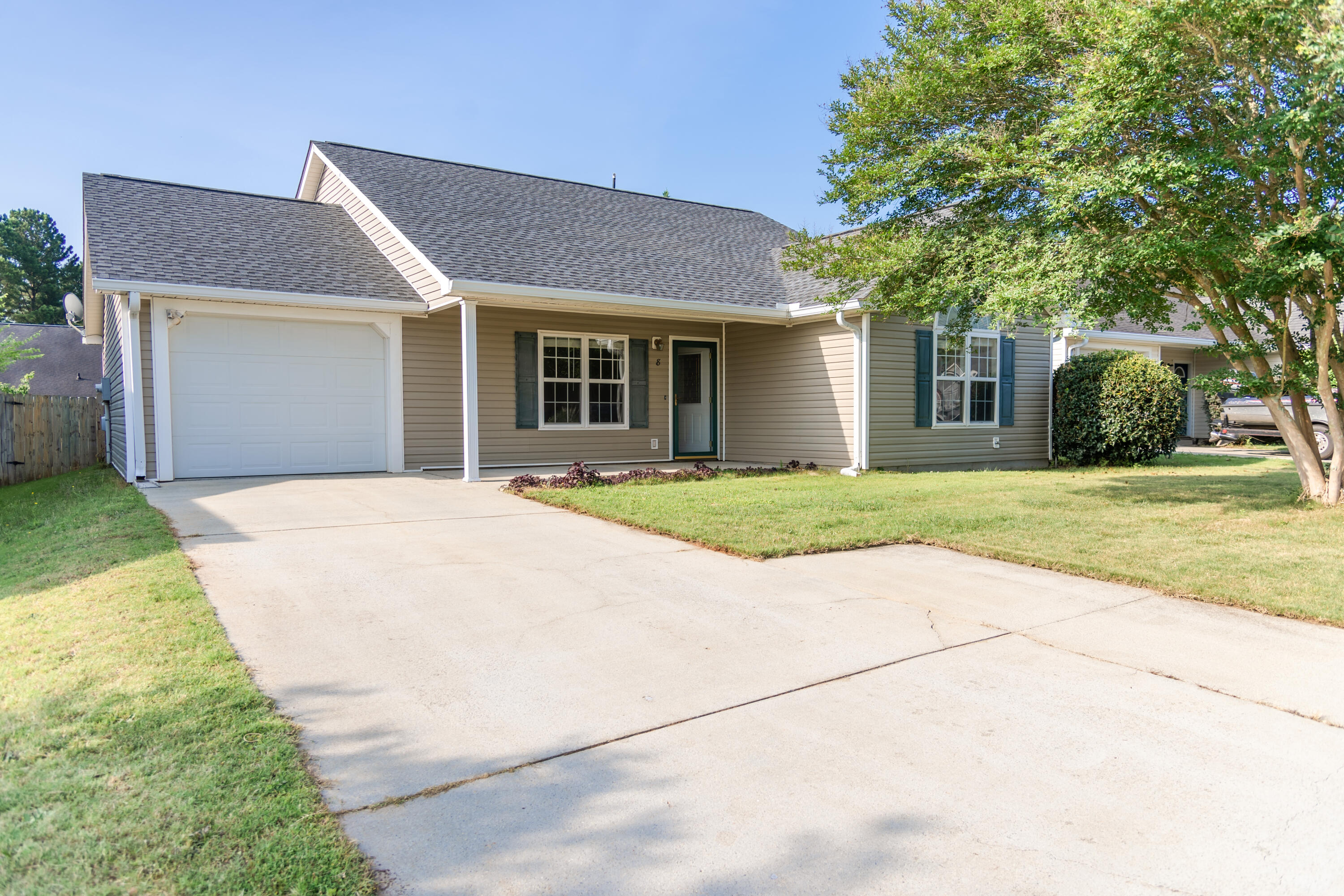 8 Chappells Road Aiken, SC 29803 - Photo 1 of 15 a front view of a house with a garden and trees