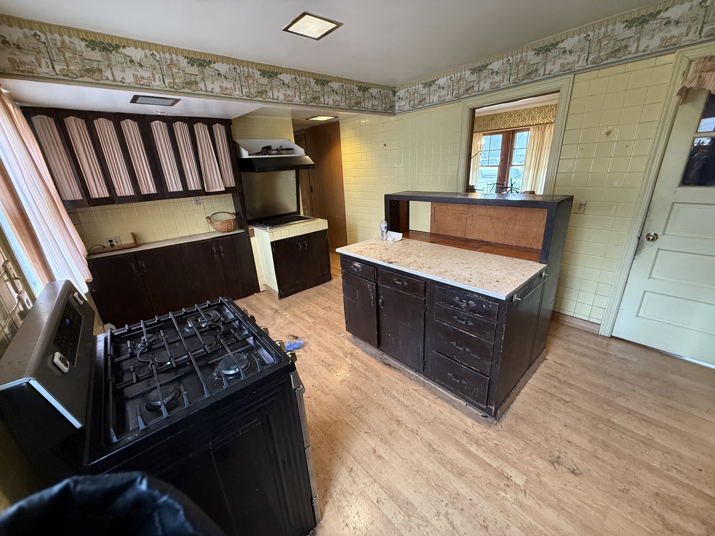 617 Meadow Drive Glenview, IL 60025 - Photo 2 of 16 a kitchen with wooden cabinets and a stove top oven
