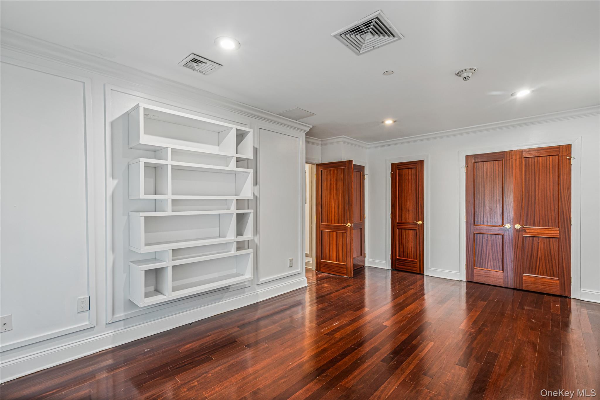 171 Great Neck Road, Unit 4R Great Neck, NY 11021 - Photo 13 of 27 a view of an empty room with a window and wooden floor