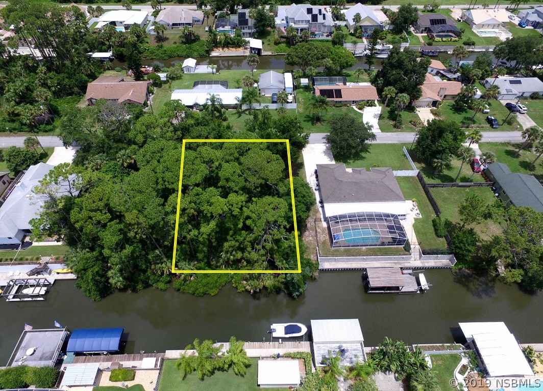 an aerial view of residential houses with outdoor space and swimming pool