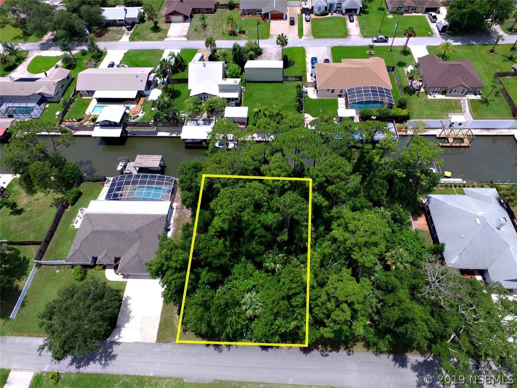 0 Azalea Road Edgewater, FL 32141 - Photo 7 of 8 an aerial view of multiple houses with yard
