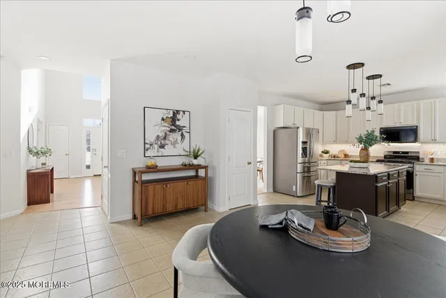 a kitchen with stainless steel appliances kitchen island granite countertop a stove and a refrigerator