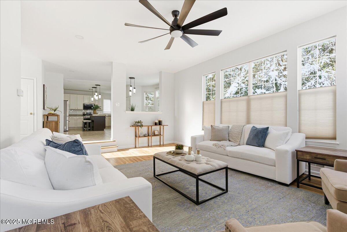 10 Sunshine Way Jackson, NJ 08527 - Photo 20 of 50 a living room with furniture and a large window with wooden floor