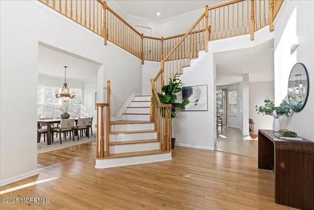 a view of entryway and hall with wooden floor
