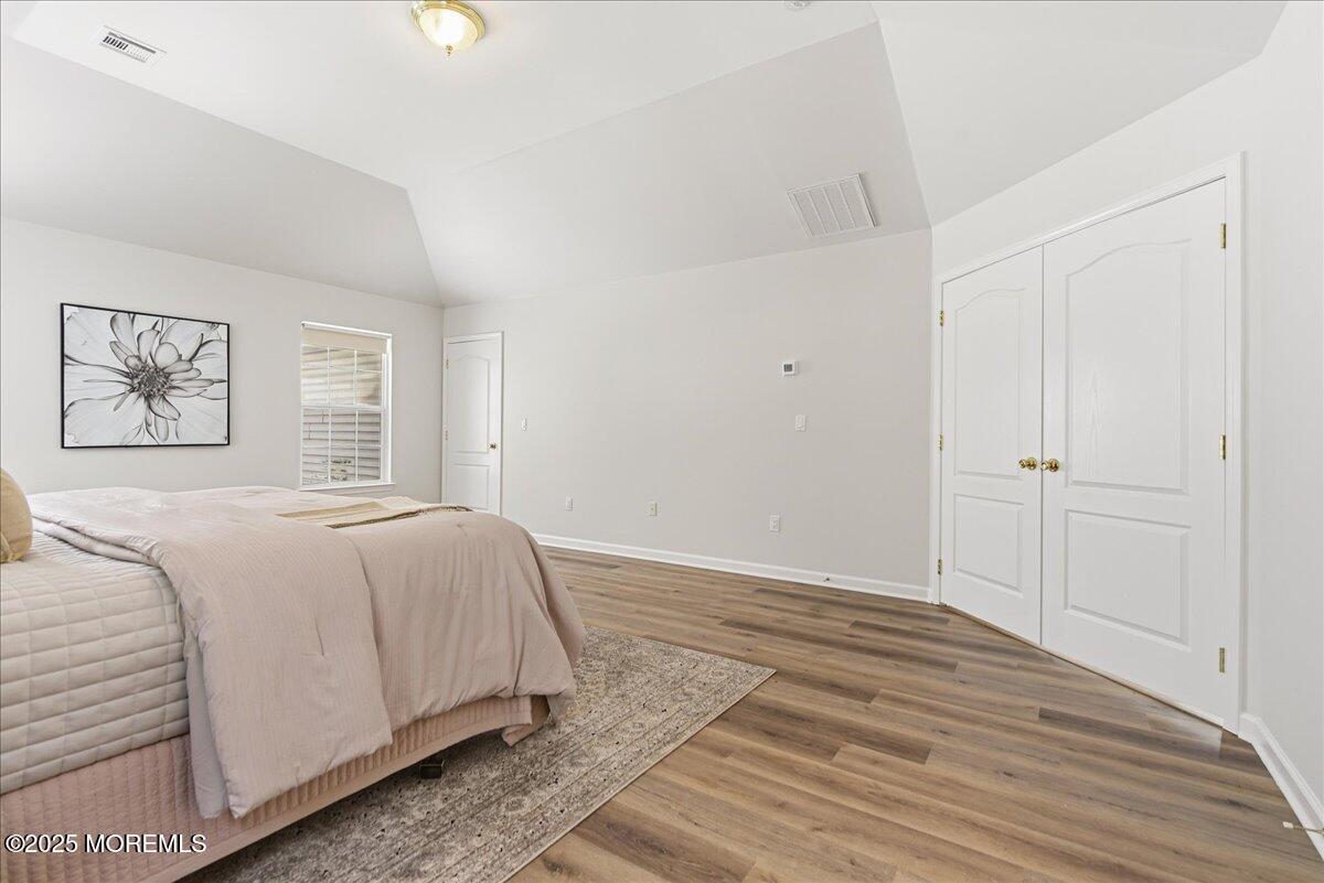 10 Sunshine Way Jackson, NJ 08527 - Photo 23 of 50 a spacious bedroom with a bed and a painting on the wall