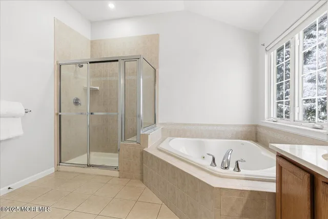 a white bath tub sitting next to a shower