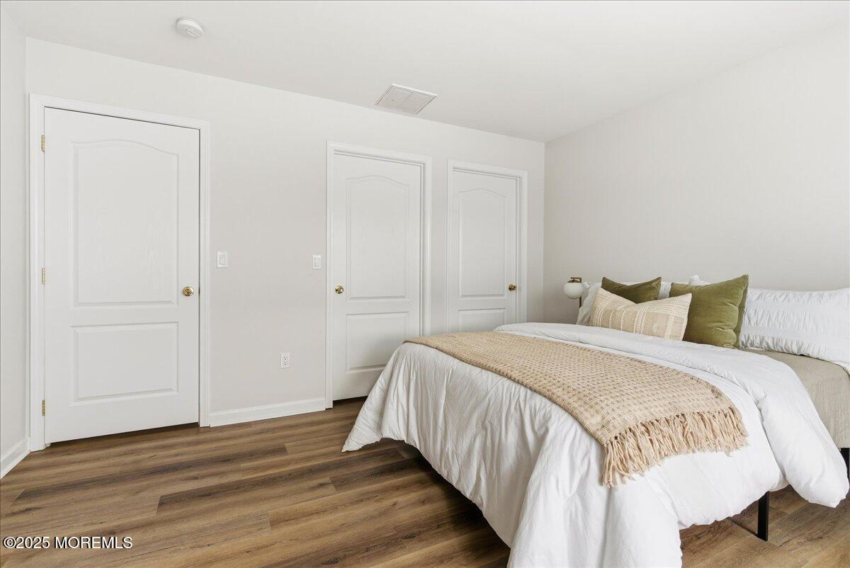 10 Sunshine Way Jackson, NJ 08527 - Photo 28 of 50 a bedroom with a bed and wooden floor