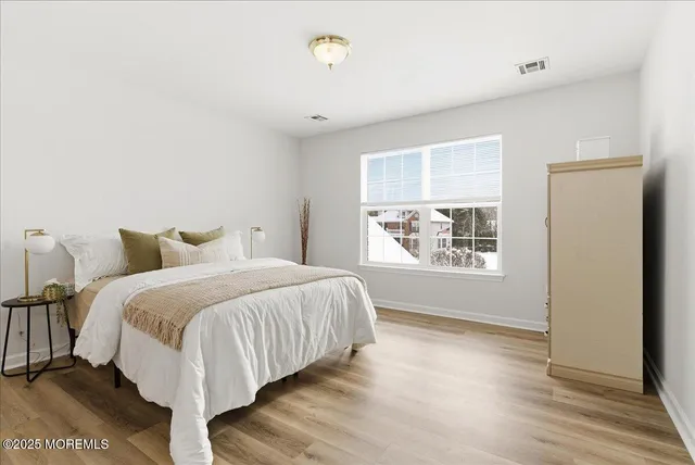 a spacious bedroom with a bed and a window