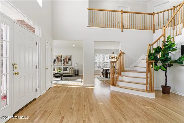 a view of entryway and hall with wooden floor