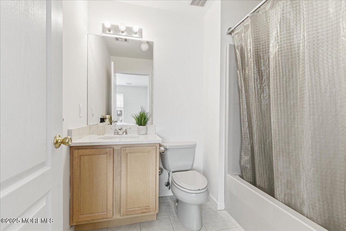10 Sunshine Way Jackson, NJ 08527 - Photo 31 of 50 a bathroom with a sink a toilet and shower curtain