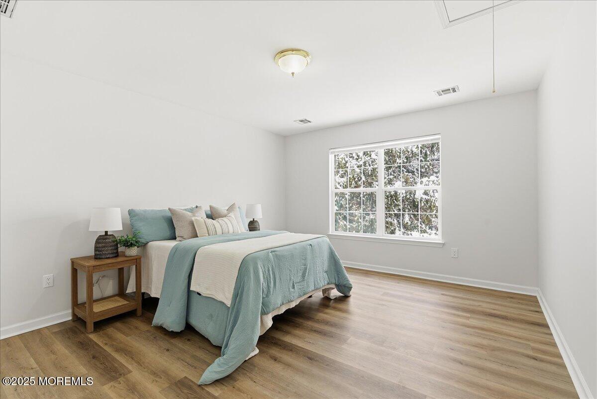 10 Sunshine Way Jackson, NJ 08527 - Photo 33 of 50 a spacious bedroom with a bed and a window