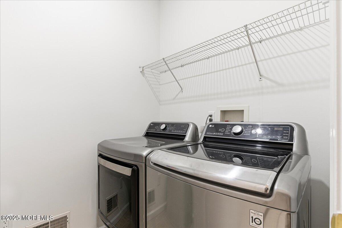 10 Sunshine Way Jackson, NJ 08527 - Photo 38 of 50 a close up view of washer and dryer