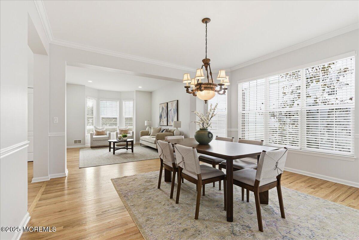 10 Sunshine Way Jackson, NJ 08527 - Photo 9 of 50 a view of a dining room and livingroom with furniture wooden floor a chandelier