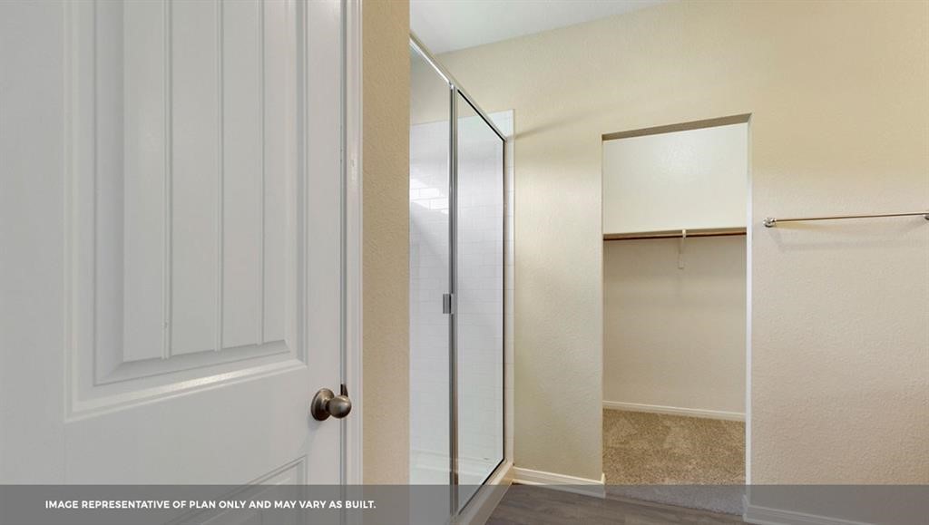 14909 Custis Lane Austin, TX 78725 - Photo 11 of 21 a bathroom with a glass shower door