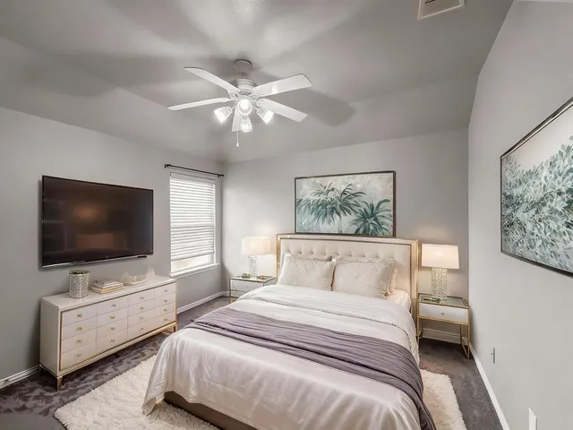 a bedroom with a large bed and a flat screen tv