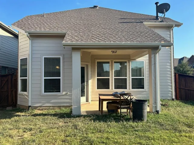 a backyard of a house with yard and outdoor seating