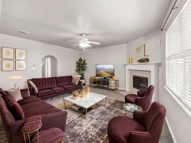 a living room with furniture fireplace and window