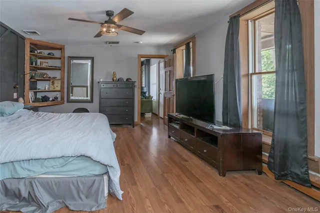 a bedroom with furniture and flat screen tv