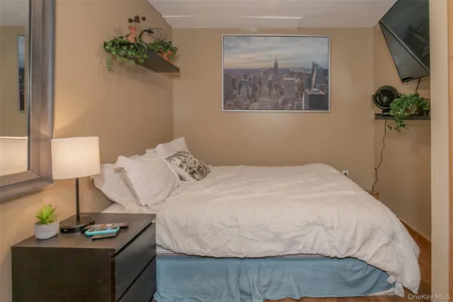 a bedroom with a bed table and a potted plant