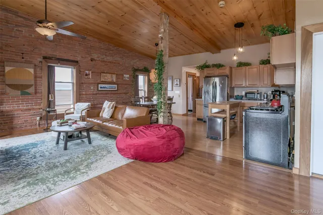 a living room with furniture a dining table and kitchen view
