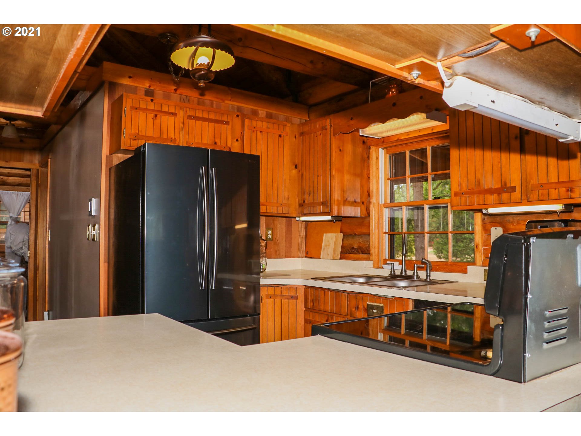 333 Coates Road Tenmile, OR 97481 - Photo 7 of 27 a kitchen with stainless steel appliances kitchen island granite countertop a refrigerator and a stove