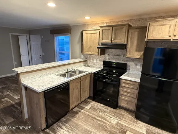 a kitchen with granite countertop stainless steel appliances and wooden cabinets