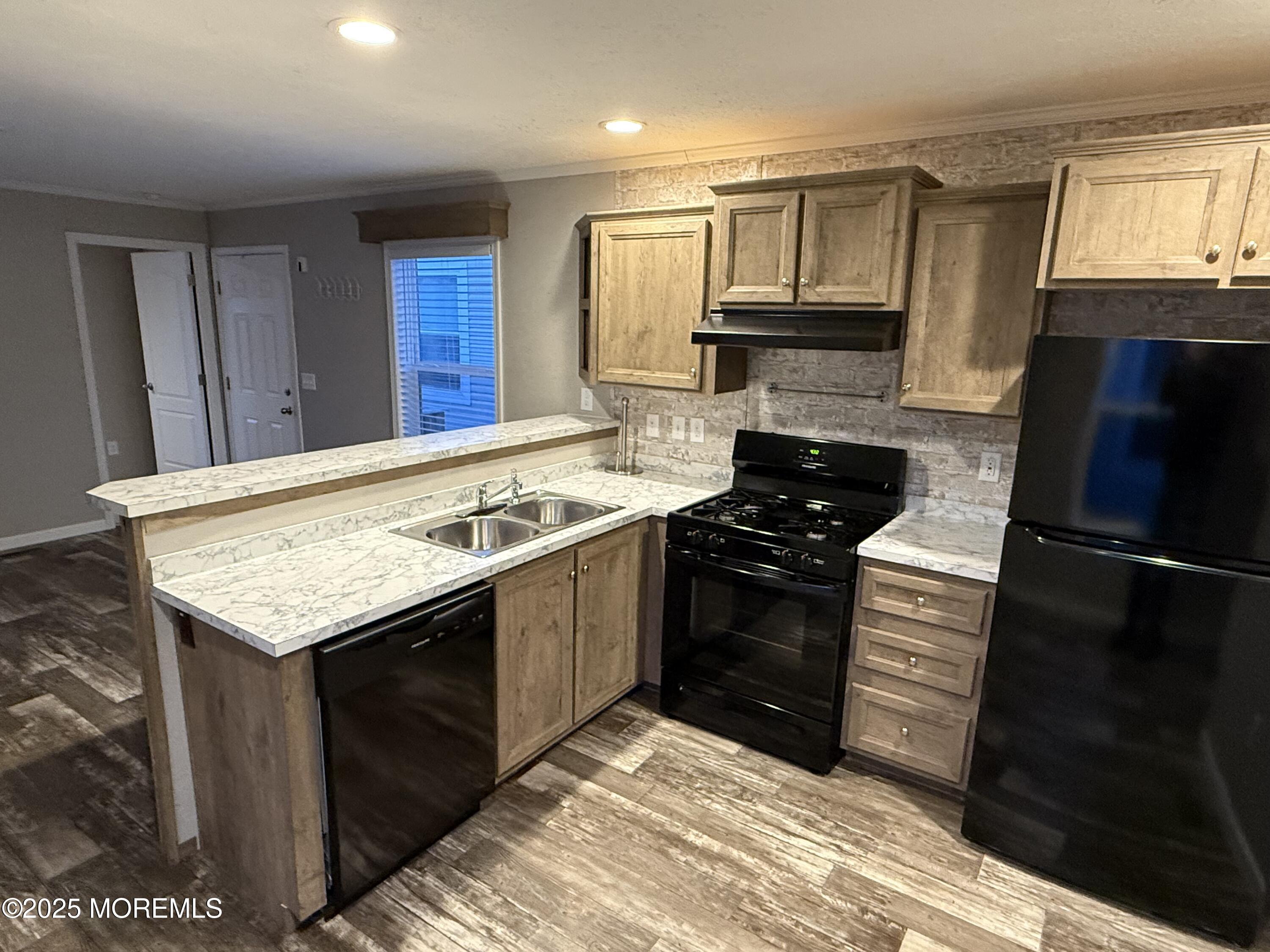 a kitchen with granite countertop stainless steel appliances and wooden cabinets