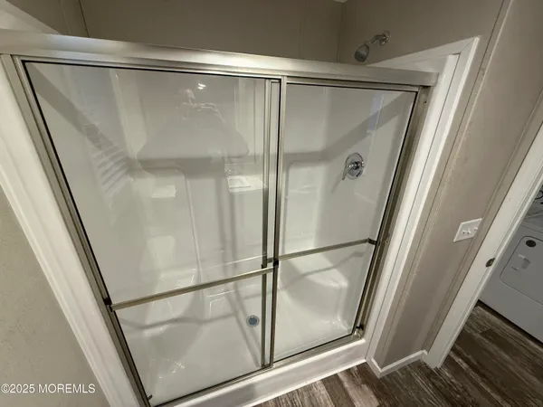 a bathroom with a glass shower door